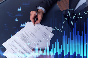 A client in formal wear is signing the contract to invest money in stock market. Internet trading...