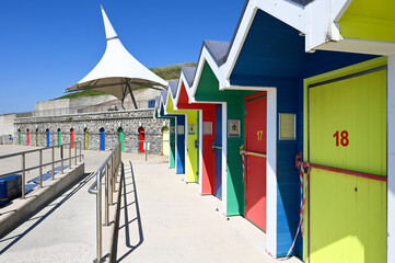 A row of colorful beach huts at Barry Island, Wales, UK