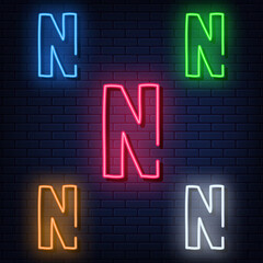 Neon letters, five colors: red, blue, green, yellow, white. Isolated font on a blue brick wall background. Vector illustration eps 10.