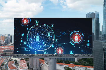 Glowing Social media icons on road billboard over panoramic city view of Singapore, Southeast Asia. The concept of networking and establishing new connections between people and businesses.