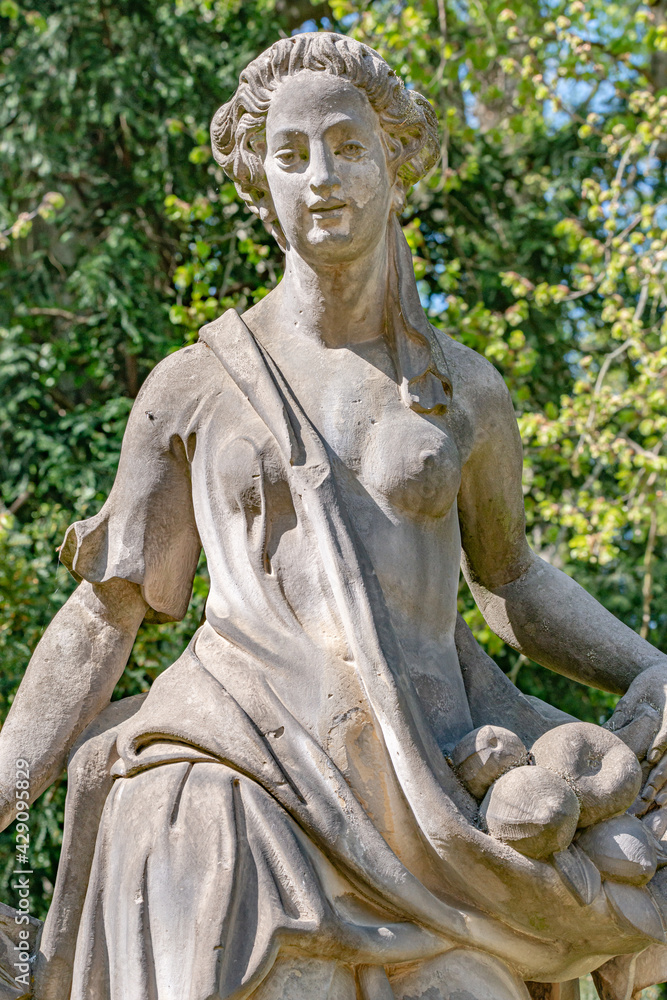 Poster ancient decayed statue of a sensual renaissance era woman in the central city park of potsdam, a ger