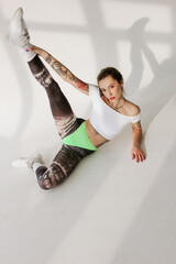 Beautiful tattooed woman on white