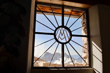 Zugspitze, Germany: A window looks out from the Maria Heimsuchung Chapel. It's  surrounded by Austrian and German alps. The chapel was consecrated in 1981 by the emeritus Pope Benedict XVI.