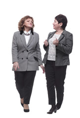 in full growth. two mature women striding forward