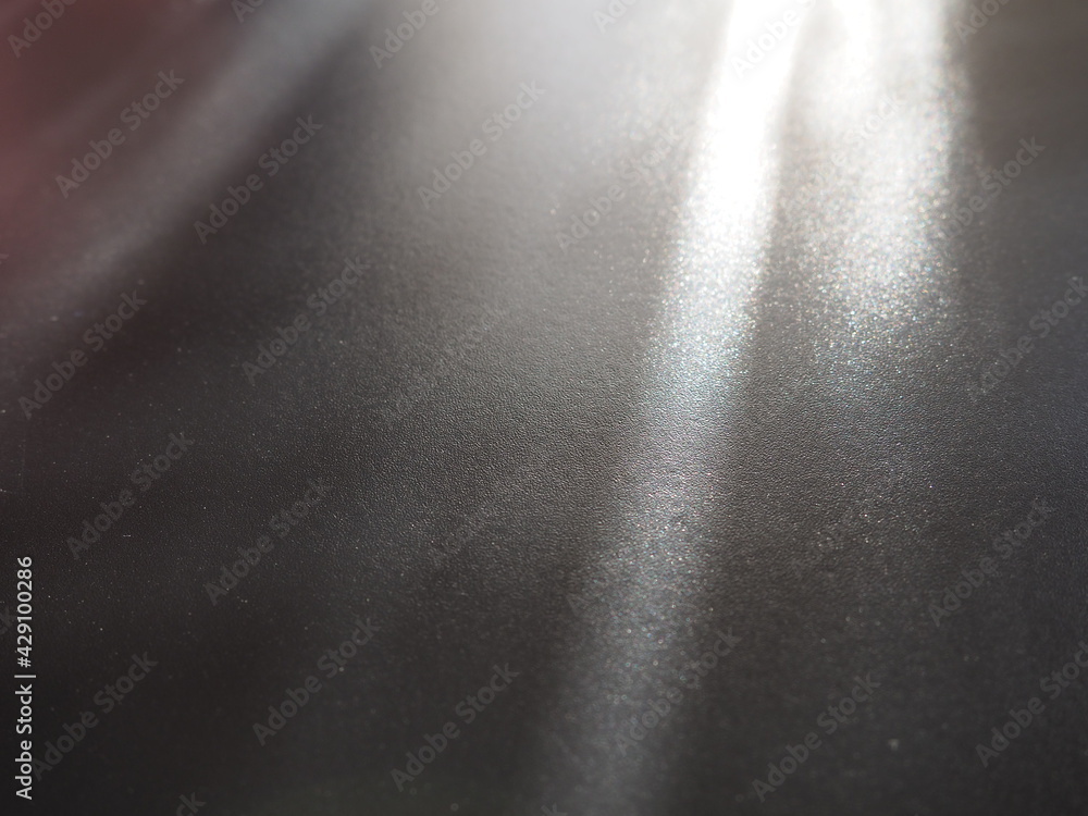 Poster illumination rays on gray surface. abstract rays of light and lens flare on a gray background. verti