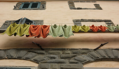 Drying colorful laundry in an ancient Tuscan town