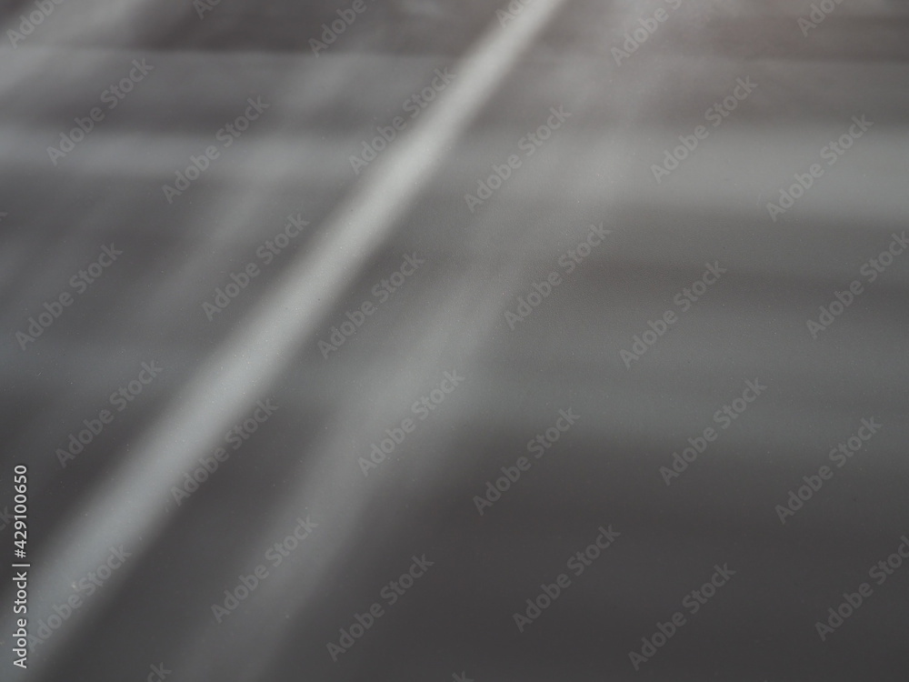 Poster illumination rays on gray surface. abstract rays of light and lens flare on a gray background. verti