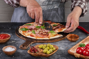 Pizza preparation with chef hands. Pizza making process decorating pizza