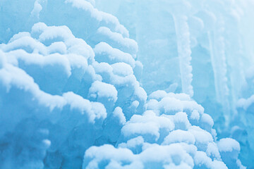 Macro background of snow and icicles. Close-up winter landscape. Beautiful blue ice and snow formations.