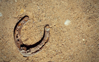 Rusty old horseshoe on the sand