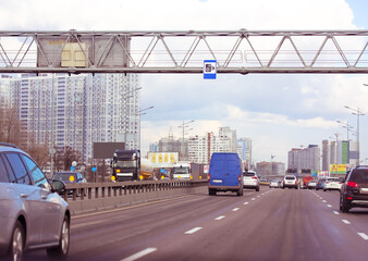 Moving cars on the motorway highway, road in a big city on a cloudy day. Traffic Safety or speed...