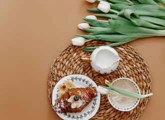 Flat Lay Morning coffee for mother day, 8 march. Coffee Cup, croissant on brown background