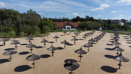 Straw umbrellas on the beach on a sunny day. The concept of rest and relaxation.
