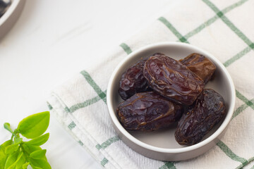 Kurma dan Air Putih, Medjool Dates and water on marble white background. Breakfasting concept in Ramadan month. Islamic template for text background. 