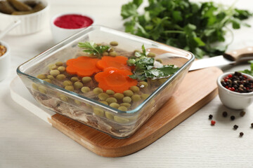 Delicious aspic in glass bowl on white wooden table