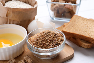 Fresh breadcrumbs, flour and egg on table