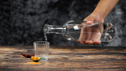 Barman pouring tequila into a shot