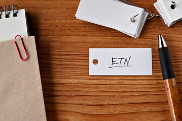 There is a word book with the word ETN written on it. It is an abbreviation for financial term...