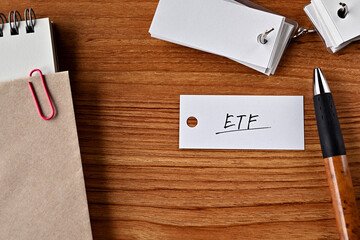There is a word book with the word ETF written on it. It is an abbreviation for financial term Exchange Traded Fund.