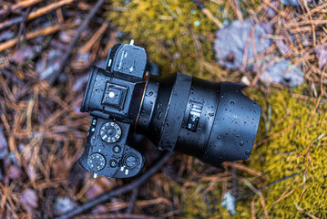 Selective focus shot of a wet camera on the ground