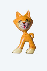 The wall decoration is made of wood, shaped like an cat, and is painted with batik motif, isolated on white background 