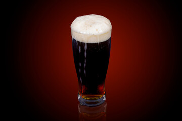 Craft Beer, Dark lager beer,Coffee infused beer with a flow of beer foam  on the glass on The...