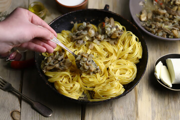 Cooking fettuccini pasta. Pasta with mushrooms.