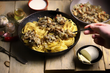 Cooking fettuccini pasta. Pasta with mushrooms.