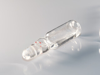Selective focus shot of a transparent ampoule isolated on a white background