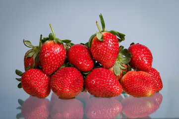 Strawberry on a blue background with low reflection