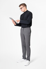 Businessman in turtleneck working on tablet full body shot