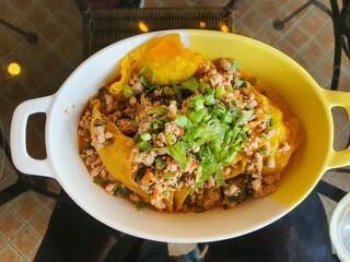 Pork Salad  in a Bowl on a Glass Table
