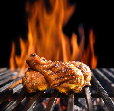 Grilled chicken legs on the flaming grill