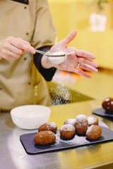 Woman working on confectionery in kitchen