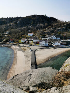 Vertical shot of houses on the shore of Kjerringvik, Norway
