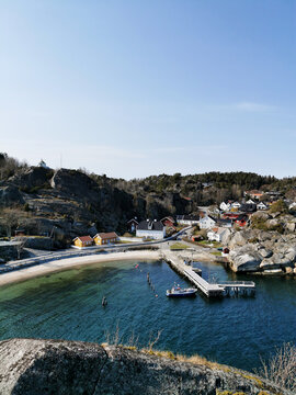 Vertical shot of a rocky shore with houses near the sea in Kjerringvik, Norway