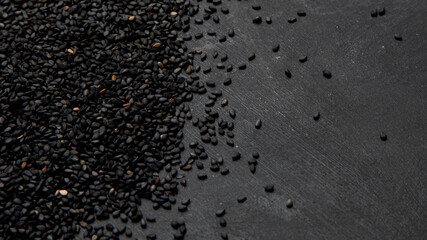 Black sesame seed on black background. Organic food concept.