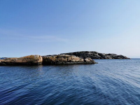 Beautiful shot of stone formations on the water in Kjerringvik, Norway