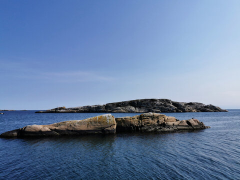 Beautiful shot of stone formations on the water in Kjerringvik, Norway