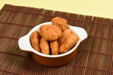 A portion of breaded chicken in a ceramic bowl
