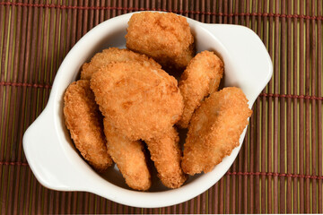 A portion of breaded chicken in a ceramic bowl