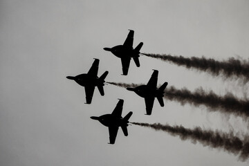 Silhouette of military jets flying in formation