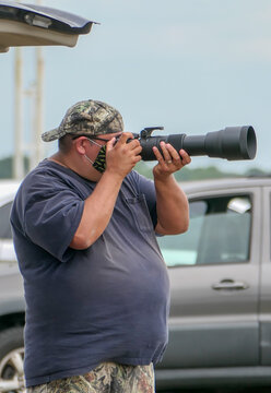 overweight male photographer with camera