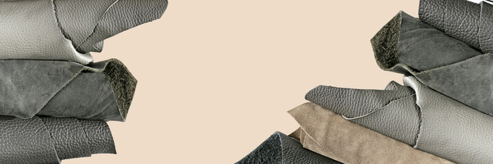 Gray genuine leather banner.Rolls of leather in gray tones  on  beige background.Leatherworking...