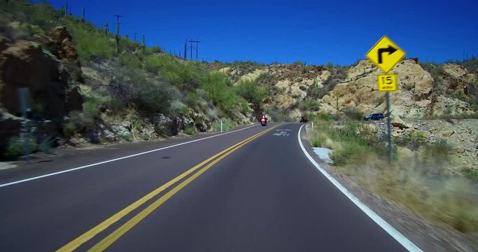 Driving Apache Trail Toward Apache Junction Various Gentle And Sharp Curves With Views Of Canyon Lake Arizona Passing 4 Vehicles And Two Motorcycles Coming From Opposite Direction 