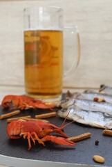 On a white background, a black board.
Where to exchange a glass of cold beer and seafood
Fish, crayfish and quick snacks. Focus on marine product - red crayfish