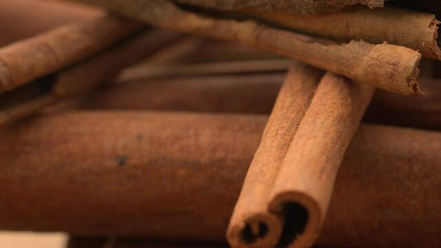 Christmas cinnamon isolated. Spices. Cinnamon rotates. Cinnamon sticks rotate on background. Fragrant cinnamon seasoning. &nbsp;Spicy cinnamon seasoning for baked goods, fruit desserts, puddings and drinks