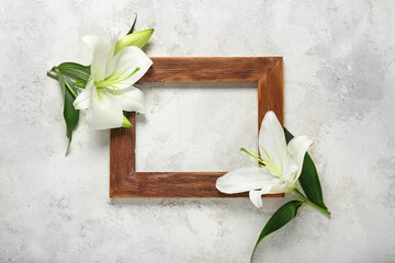 Beautiful lily flowers and frame on light background