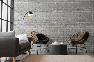 Interior of modern living room with armchairs and ottoman