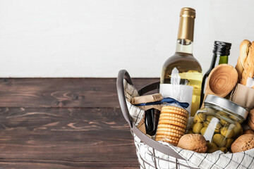 Gift basket with products on wooden table